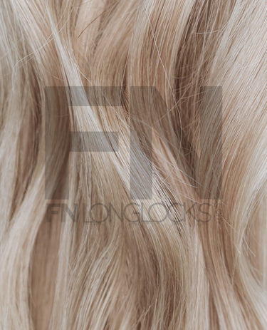 Luxury blonde human hair extensions with natural shine and smooth texture, perfect for seamless blending.