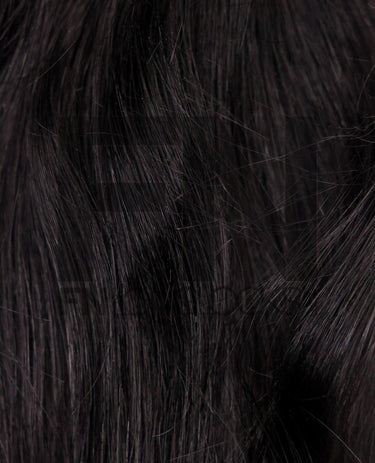 Luxury real human remy hair extensions with sleek, dark strands for natural volume and length.