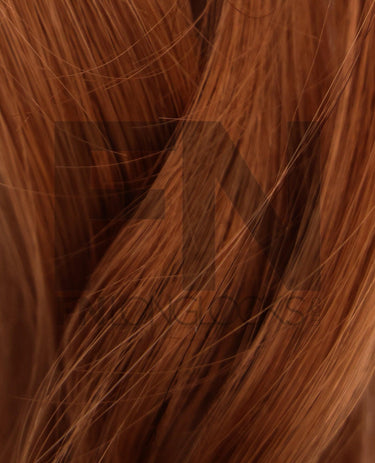 Luxury real human Remy hair extensions in rich auburn shade, smooth and silky texture for natural volume.