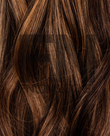 Luxury real human remy hair extensions with smooth, shiny brown strands for natural volume and length.