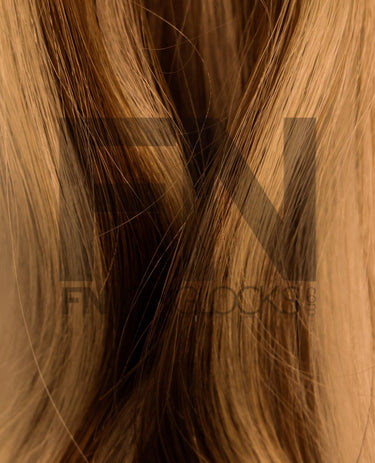 Luxury human remy hair extensions with smooth, natural-looking strands in warm brown tones.