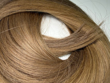 Smooth, natural-looking human hair extensions in warm brown tone, ideal for salon use