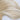 Blonde human hair extensions with smooth, flowing waves on white background