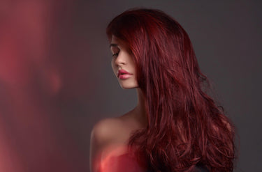 Model wearing FNLonglocks premium wine red tape-in hair extensions for seamless length and volume.