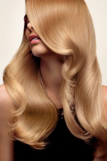 Model wearing FNLonglocks premium light auburn tape-in extensions for seamless length and volume.