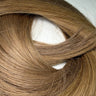 Smooth, natural-looking human hair extensions in warm brown tone, ideal for salon use