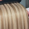 close up video of beige blonde color 8/18 piano blend hair extensions