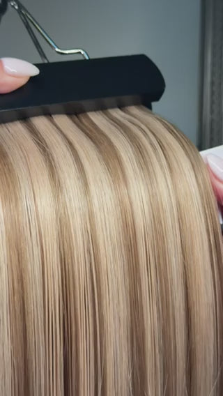 close up video of beige blonde color 8/18 piano blend hair extensions